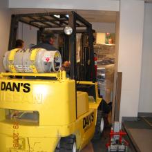 Moving new equipment through narrow hallways.