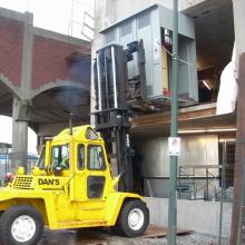 Lifting an Electrical Box into place in New Westminster.