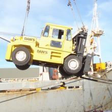 Being lifted into a ship to move large gear around.